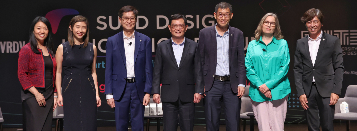 Seven people stand on stage for SUTD (Singapore University of Technology and Design).